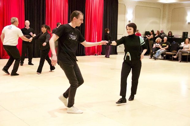 Dancing in front of a red curtain